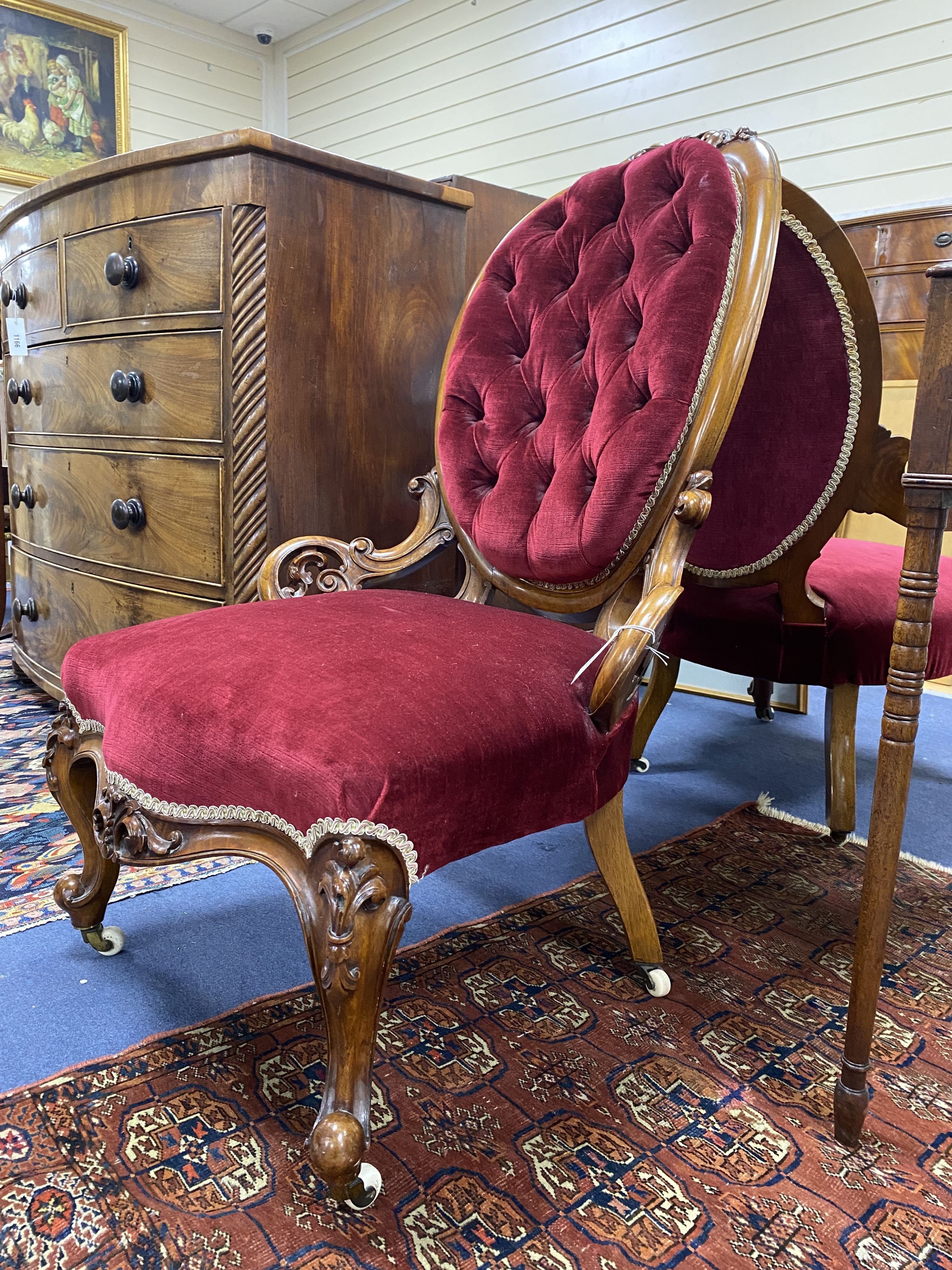 A Victorian carved walnut armchair and matching nursing chair